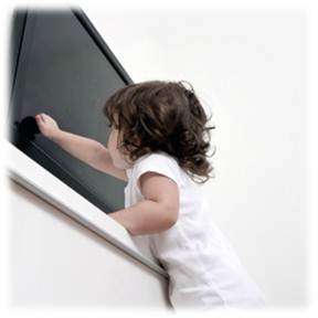Child reaching toward a television